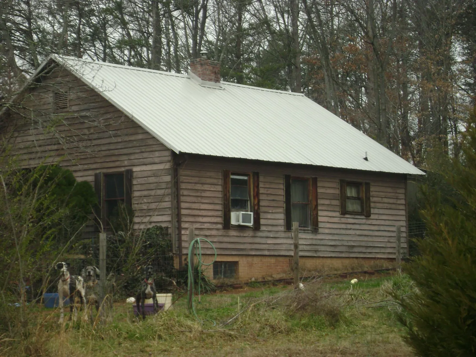 White metal roof on an old wood sided farmhouse, from a Metal Roof Installation job in Stoutsville